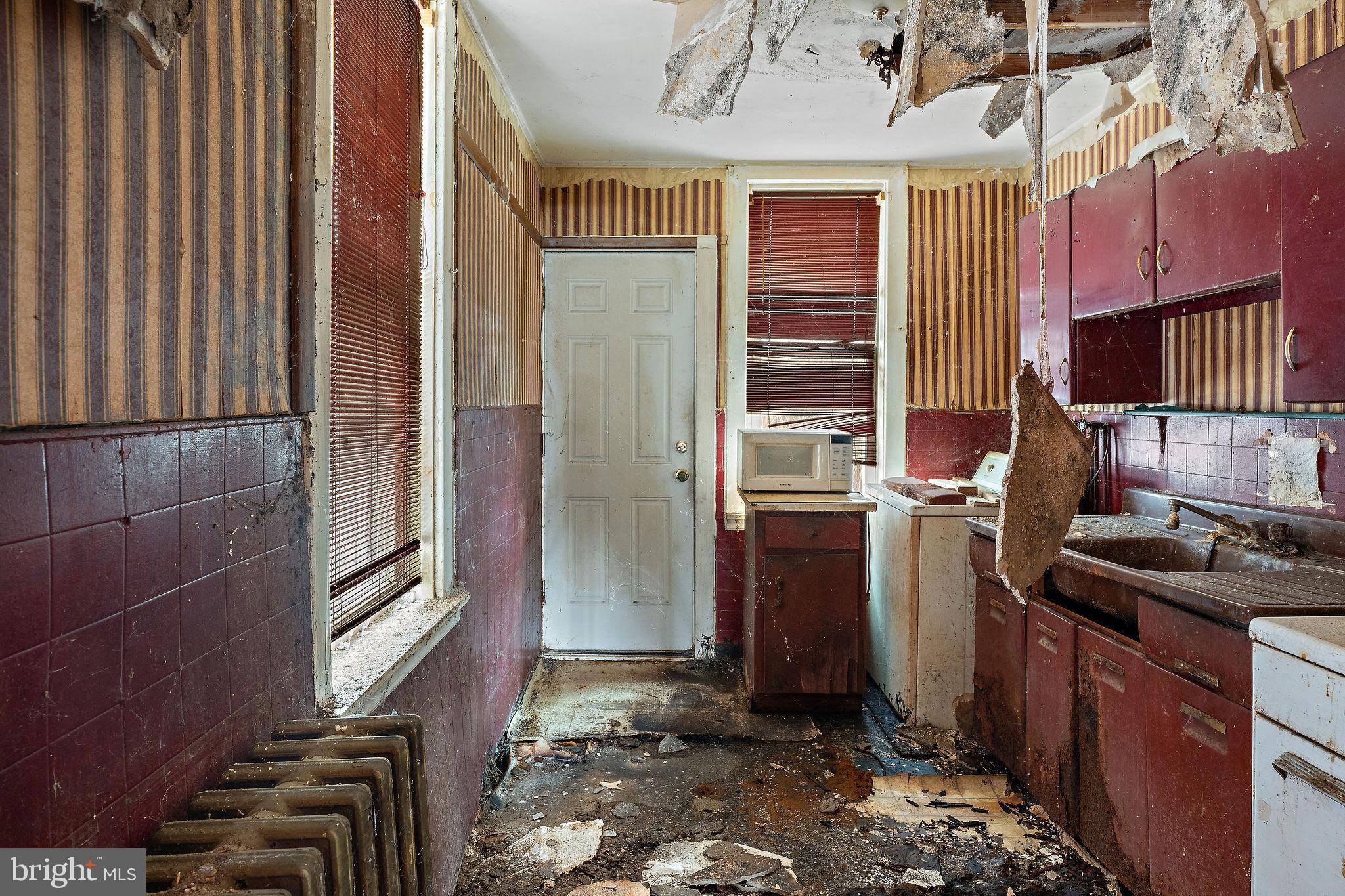 610 Point Street Camden, NJ 08102 - Photo 10 of 23 a kitchen with a sink stove and refrigerator