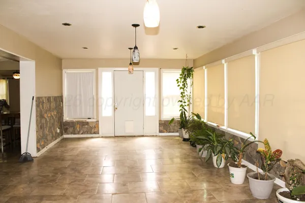 a view of an entryway with flower pots