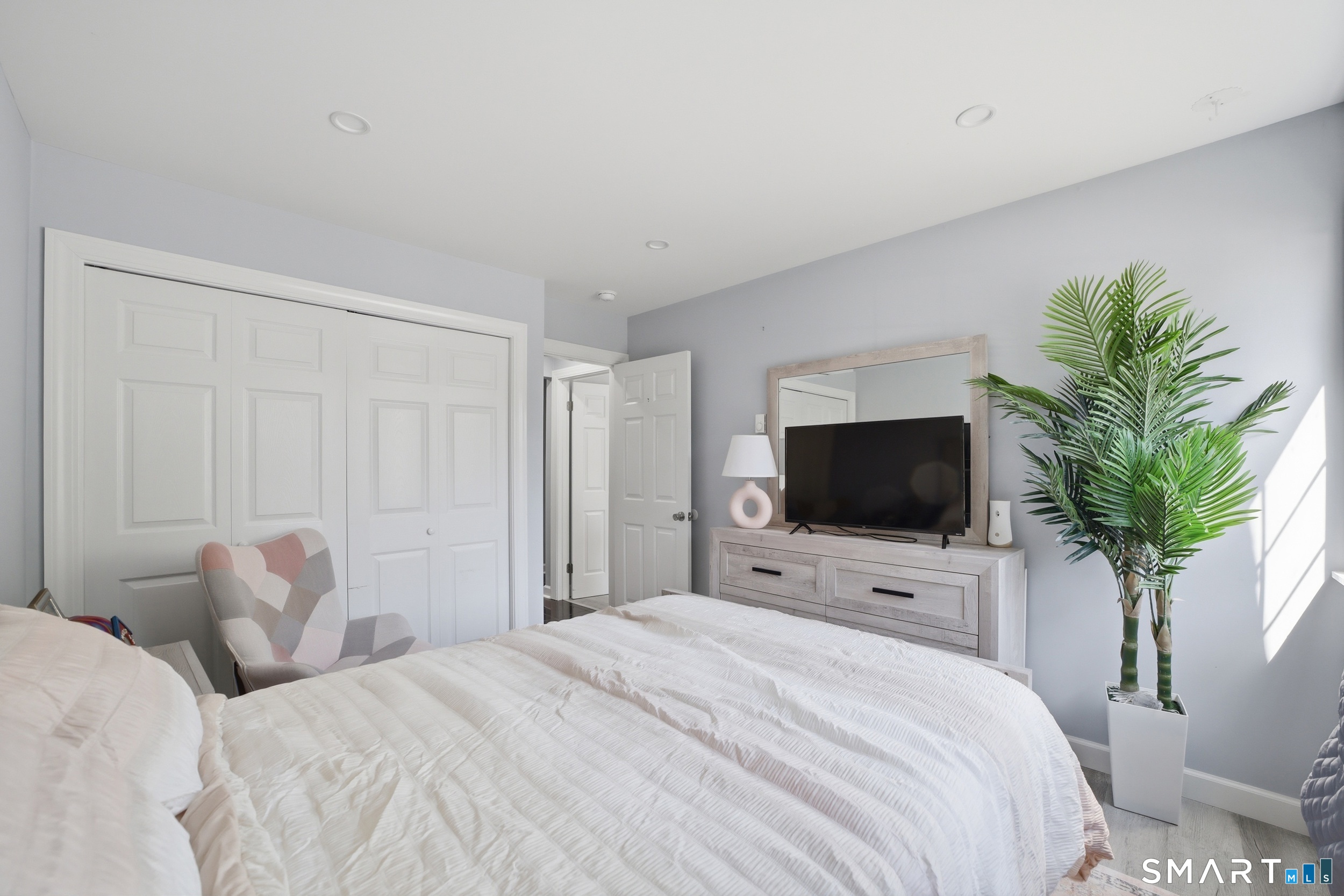 187 Flax Hill Road, Unit D1 Norwalk, CT 06854 - Photo 27 of 32 a bedroom with a bed and a flat screen tv