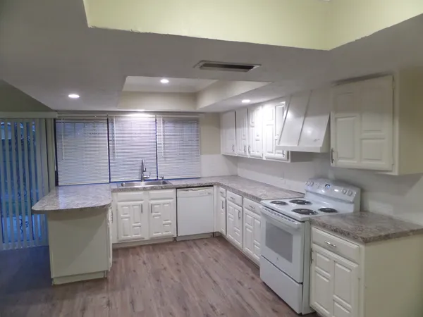 a kitchen with a sink cabinets and window