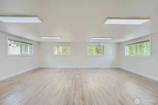 a view of an empty room with a window and a window