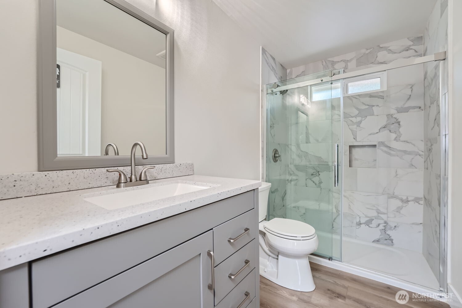 1409 Union Avenue Northeast Renton, WA 98059 - Photo 18 of 23 a bathroom with a granite countertop sink a toilet and shower
