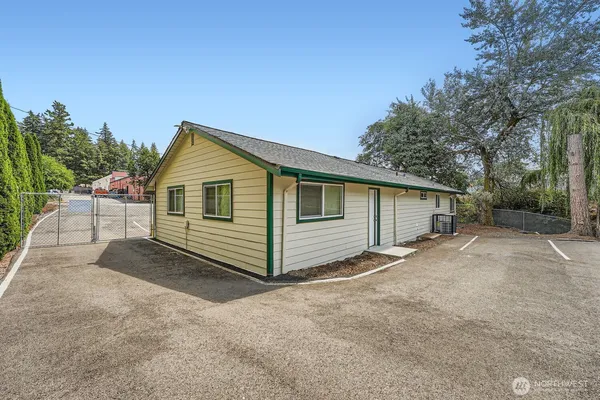 a view of a house with a yard and garage