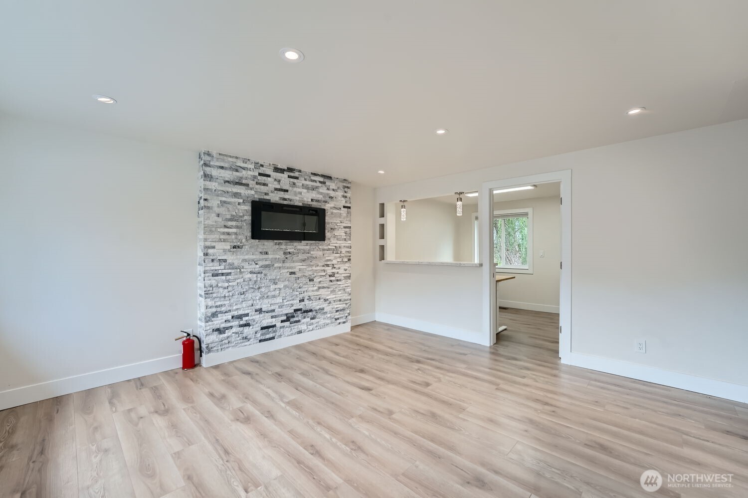 1409 Union Avenue Northeast Renton, WA 98059 - Photo 4 of 23 a view of empty room with wooden floor and fireplace