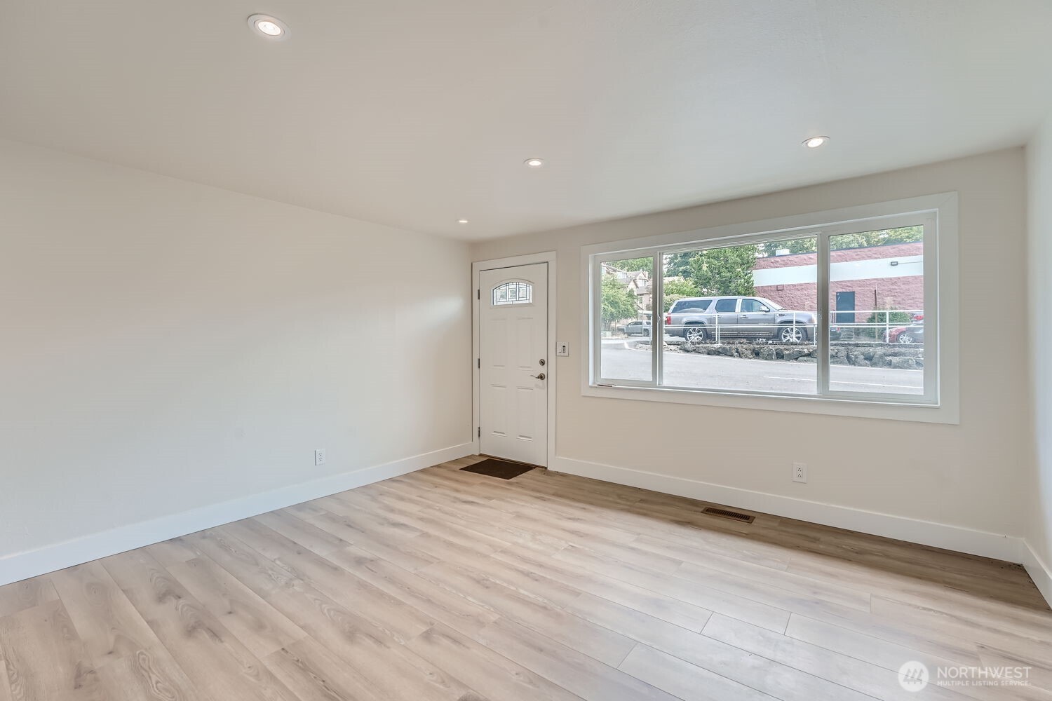 1409 Union Avenue Northeast Renton, WA 98059 - Photo 5 of 23 a view of an empty room with wooden floor and a window