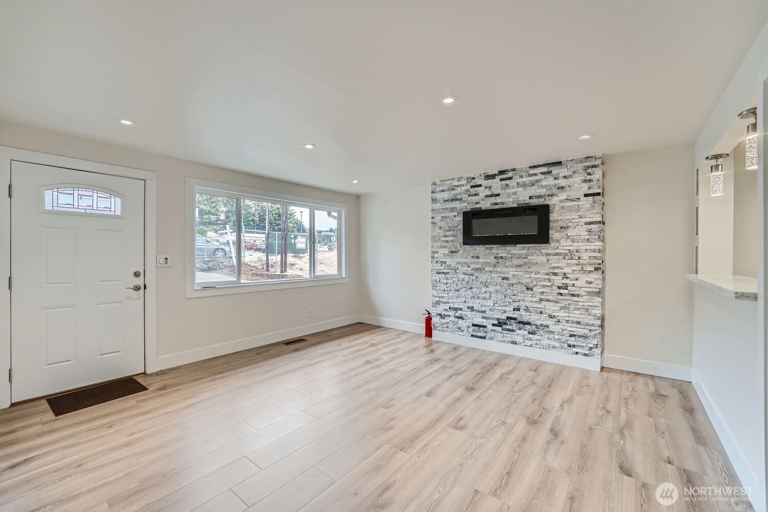 1409 Union Avenue Northeast Renton, WA 98059 - Photo 6 of 23 wooden floor in an empty room with a window