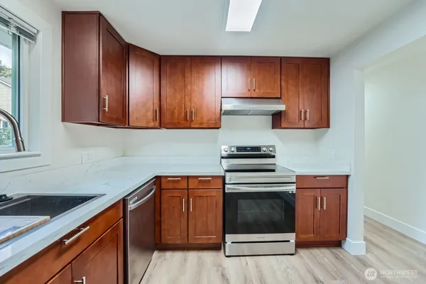 a kitchen with wooden cabinets and white appliances