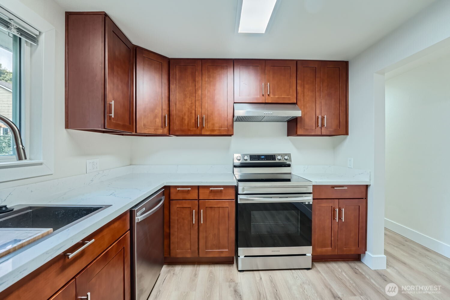 1409 Union Avenue Northeast Renton, WA 98059 - Photo 10 of 23 a kitchen with wooden cabinets and white appliances