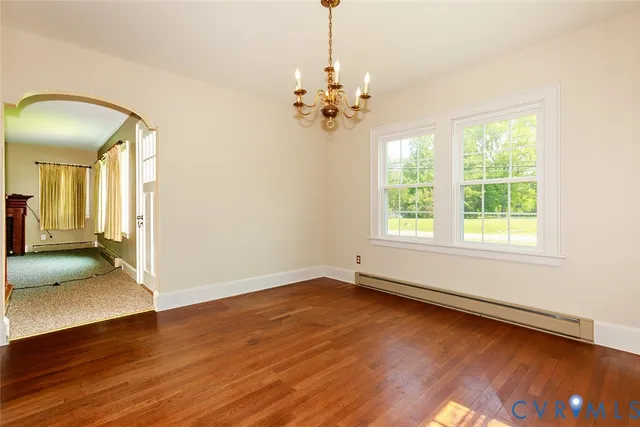 a view of a livingroom with wooden floor and a ceiling fan