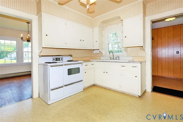 a kitchen with a stove a sink and a refrigerator