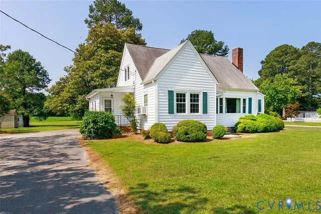 a view of a house with a big yard and potted plants