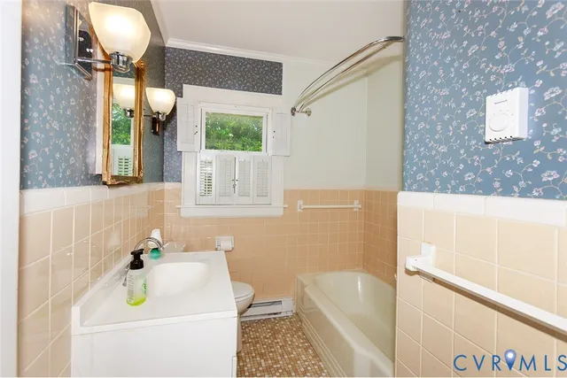 a view of a room with wooden floor and a bathroom