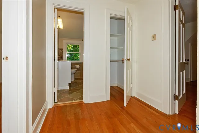 a view of a kitchen with wooden floor and a window