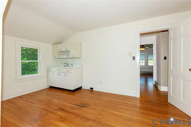 a view of a livingroom with a window and wooden floor