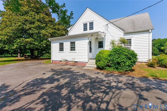 a view of a house with a yard and a garage