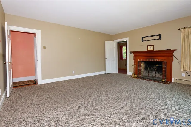 a view of an empty room with a fireplace