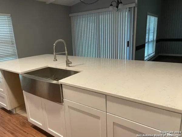 a kitchen with a sink and a refrigerator
