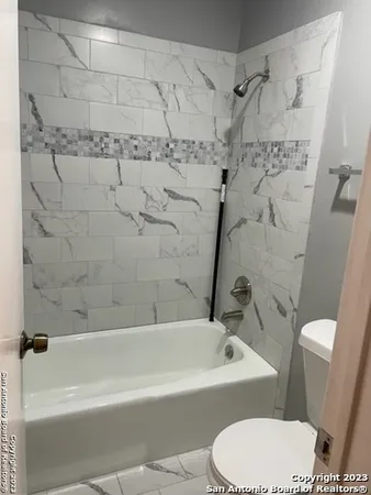 a bathroom with a toilet and a bathtub