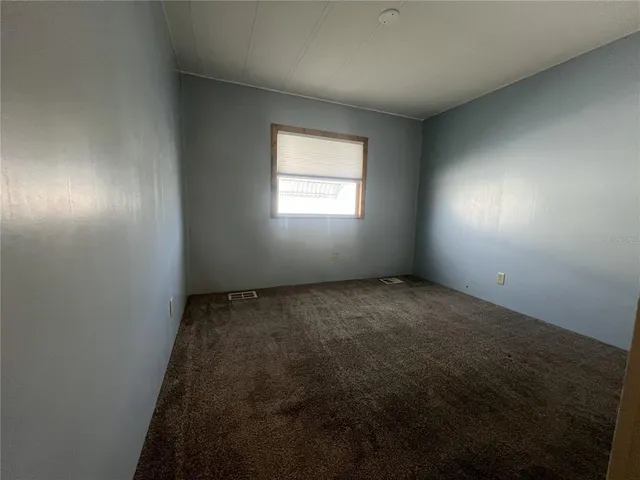 an empty room with a empty space and windows
