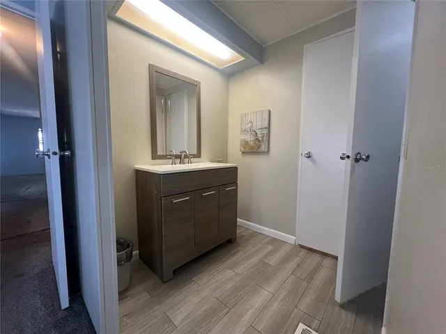 a room with a sink and a mirror