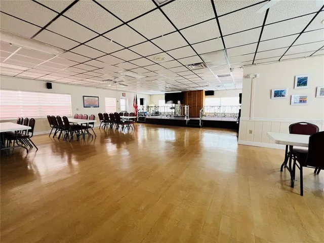 a swimming pool with chairs and table in a room