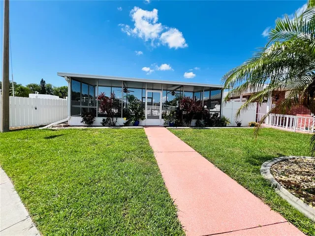 a view of a house with backyard porch and sitting area
