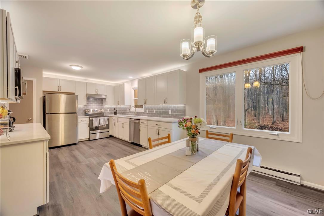 2559 Mountain Road Slatington, PA 18080 - Photo 5 of 32 a kitchen with a refrigerator a stove a sink dishwasher with a dining table and chairs