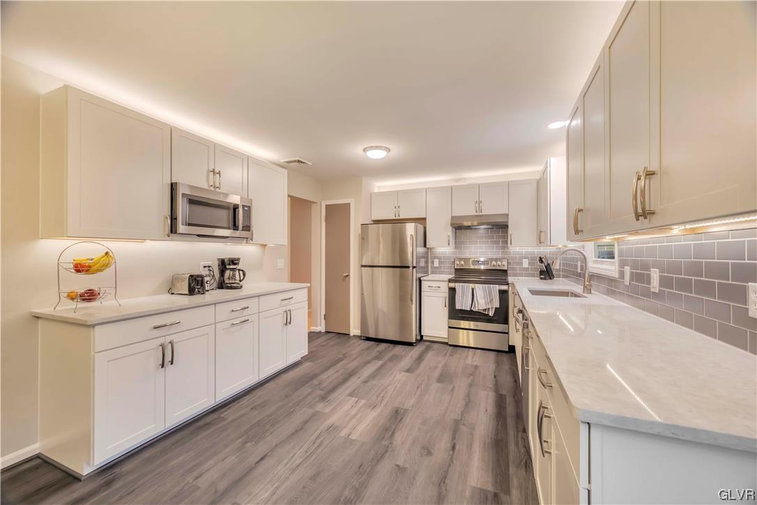 2559 Mountain Road Slatington, PA 18080 - Photo 8 of 32 a large kitchen with stainless steel appliances lots of counter space and wooden floor