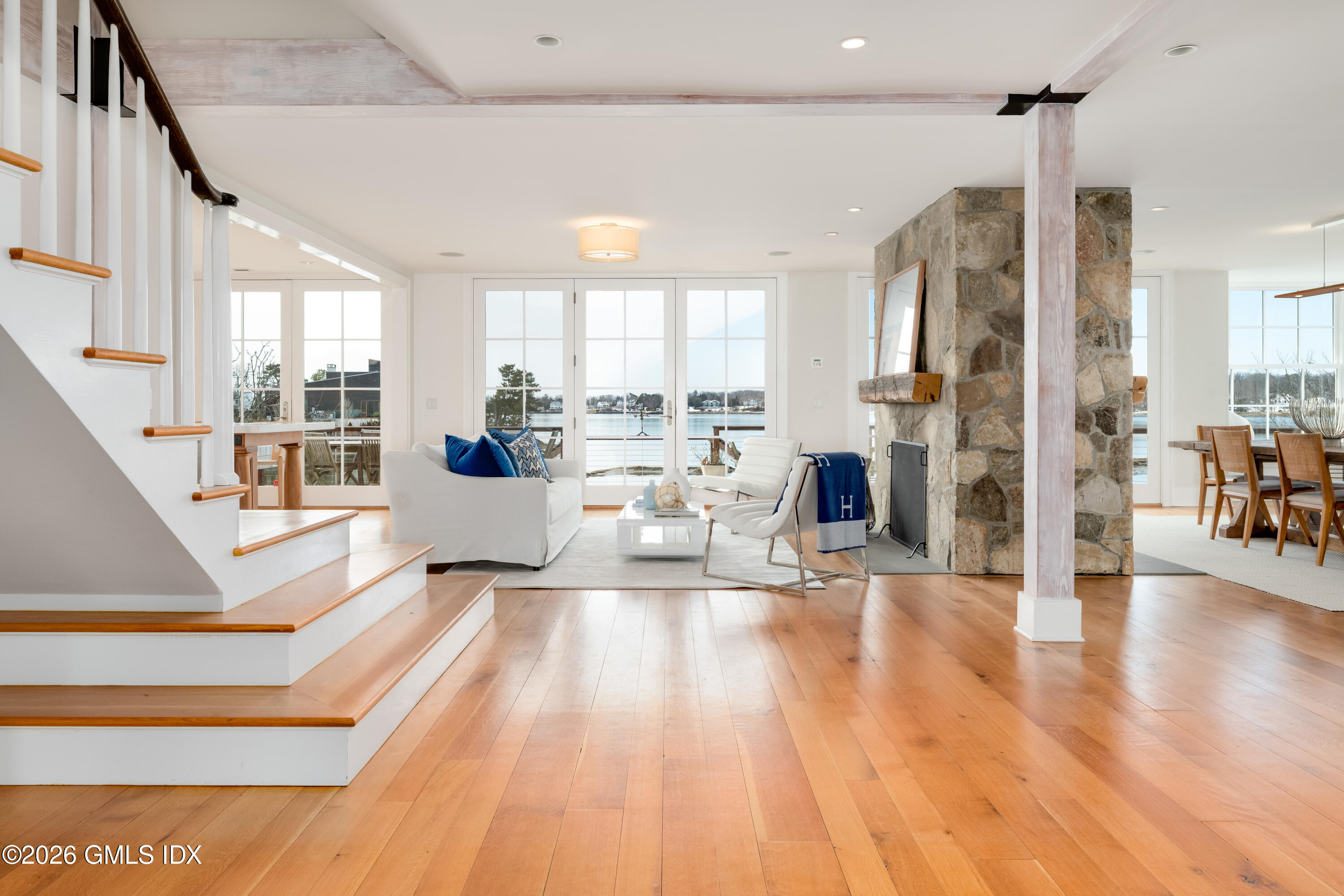 189 Shore Road Old Greenwich, CT 06870 - Photo 4 of 38 a living room with stainless steel appliances furniture a large window and wooden floor