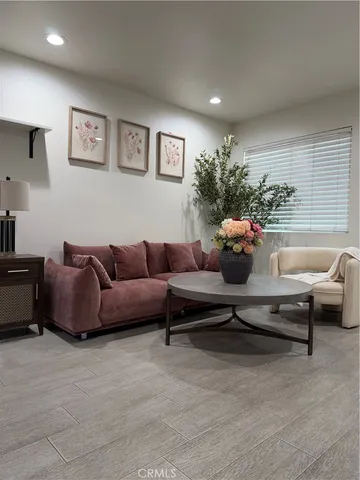 a living room with furniture and a potted plant