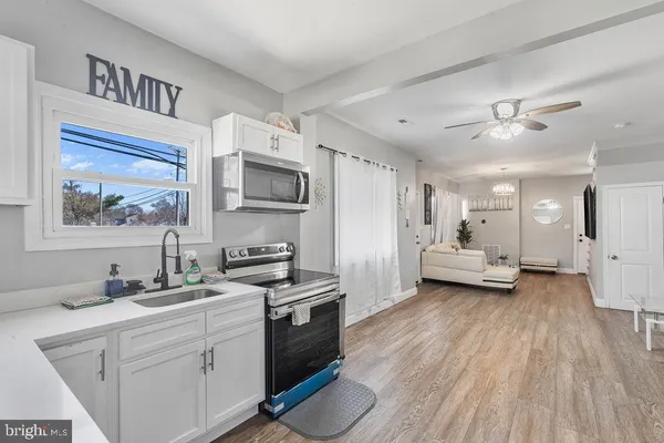 a kitchen with sink cabinets and wooden floor