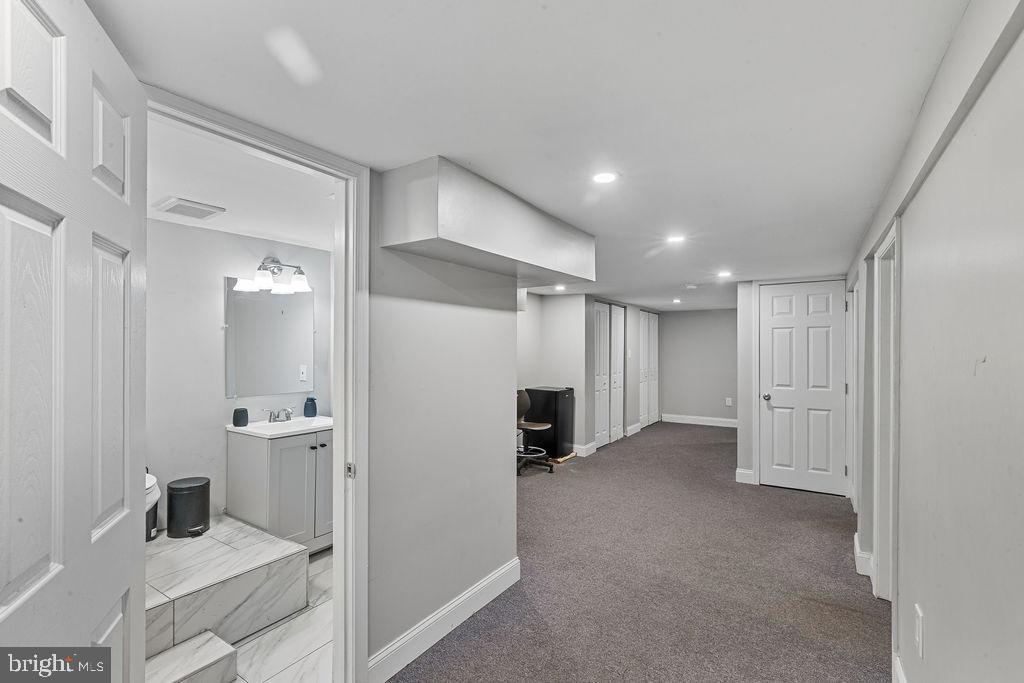 8489 Arbutus Road Pasadena, MD 21122 - Photo 15 of 41 a view of a hallway with a kitchen and a sink