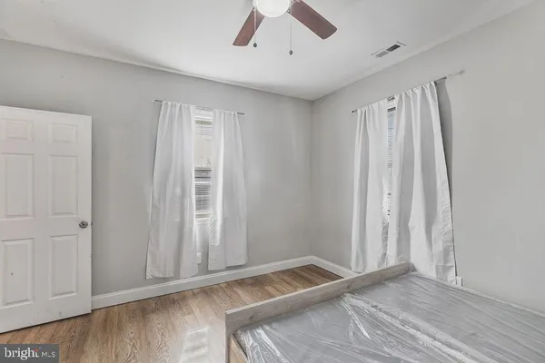 a view of room with window and hardwood floor