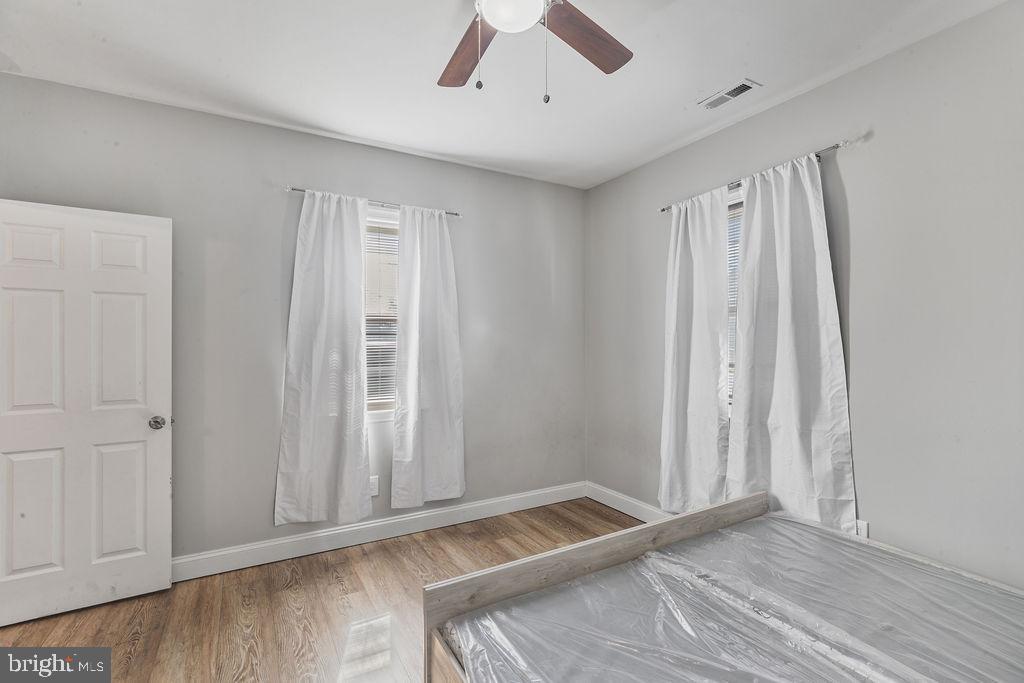 8489 Arbutus Road Pasadena, MD 21122 - Photo 19 of 41 a view of room with window and hardwood floor