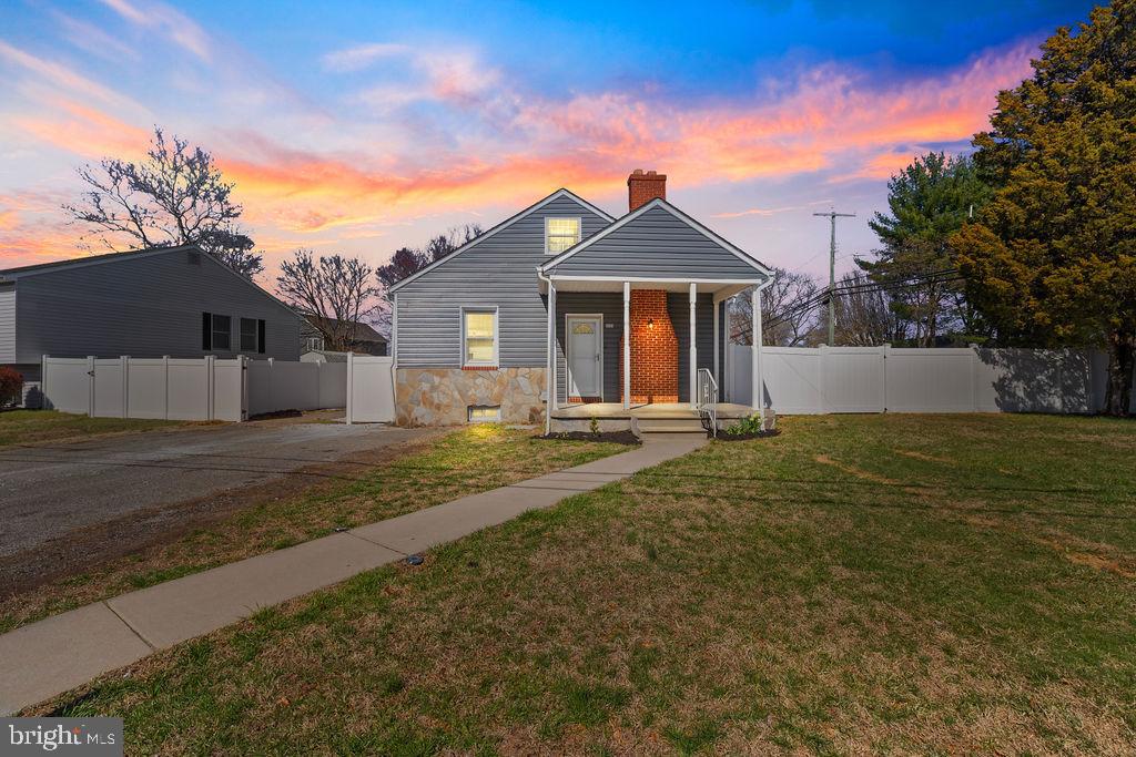 8489 Arbutus Road Pasadena, MD 21122 - Photo 2 of 41 a front view of a house with a yard