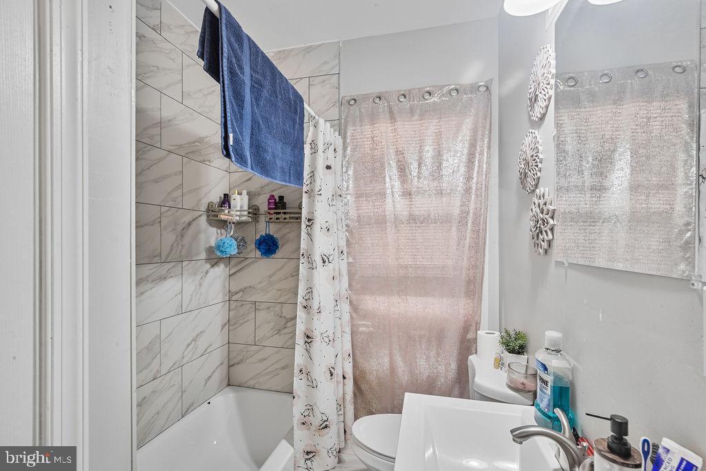 8489 Arbutus Road Pasadena, MD 21122 - Photo 21 of 41 a bathroom with a shower and a sink