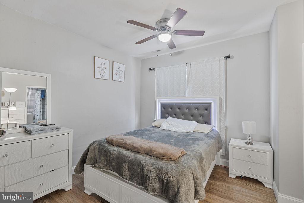 8489 Arbutus Road Pasadena, MD 21122 - Photo 22 of 41 a bedroom with a bed and a chandelier