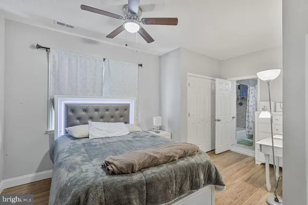 a bedroom with a large bed and a chandelier