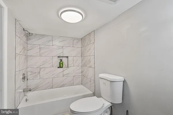 a bathroom with a toilet and a bathtub