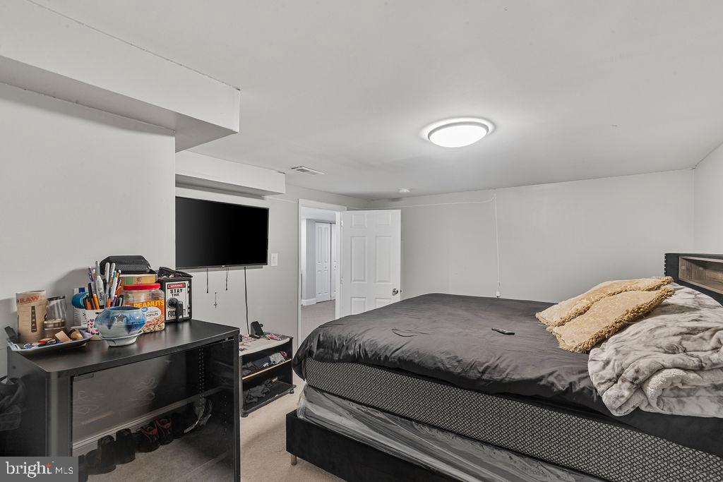 8489 Arbutus Road Pasadena, MD 21122 - Photo 28 of 41 a bedroom with a bed and a flat screen tv