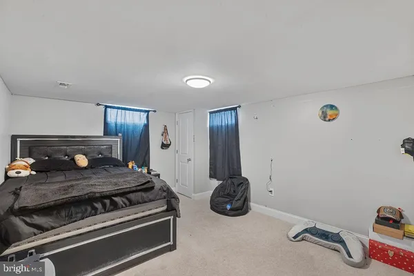 a bedroom with a bed and a large mirror