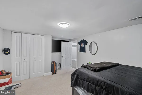 a view of staircase with railing and white walls