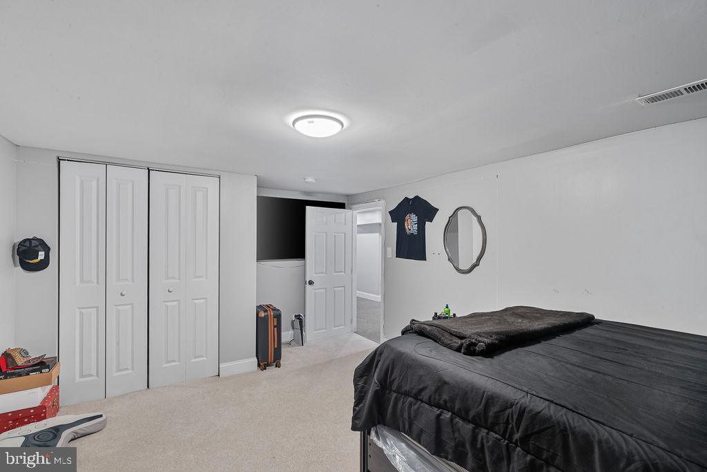 8489 Arbutus Road Pasadena, MD 21122 - Photo 30 of 41 a bedroom with a bed and a large mirror