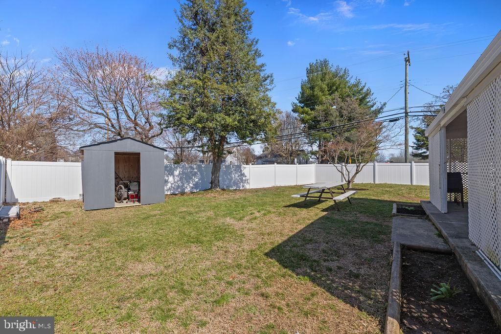 8489 Arbutus Road Pasadena, MD 21122 - Photo 38 of 41 a view of a backyard with a tree