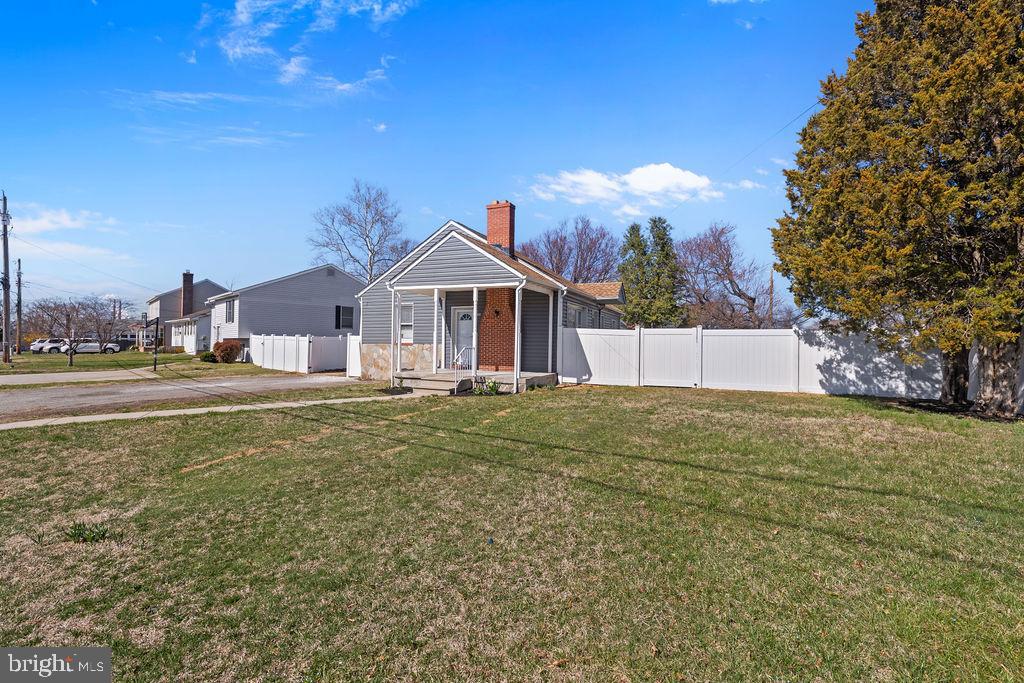 8489 Arbutus Road Pasadena, MD 21122 - Photo 4 of 41 a view of a house with a yard