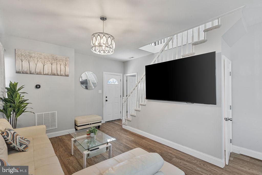 8489 Arbutus Road Pasadena, MD 21122 - Photo 5 of 41 a living room with furniture and a flat screen tv
