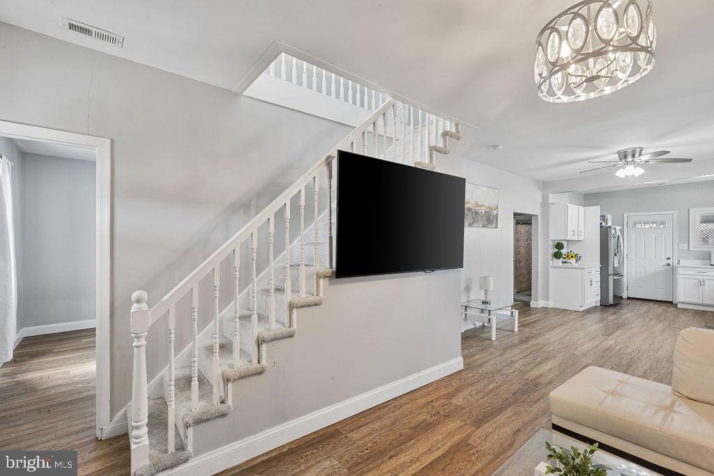 8489 Arbutus Road Pasadena, MD 21122 - Photo 6 of 41 a living room with furniture and a flat screen tv