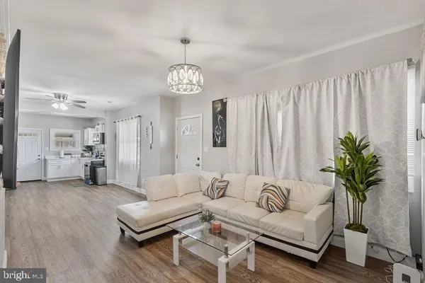 a living room with furniture potted plant and a chandelier