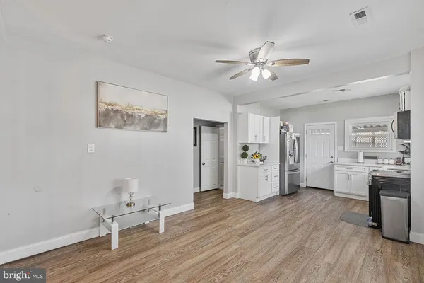 a view of a livingroom with furniture and a ceiling fan