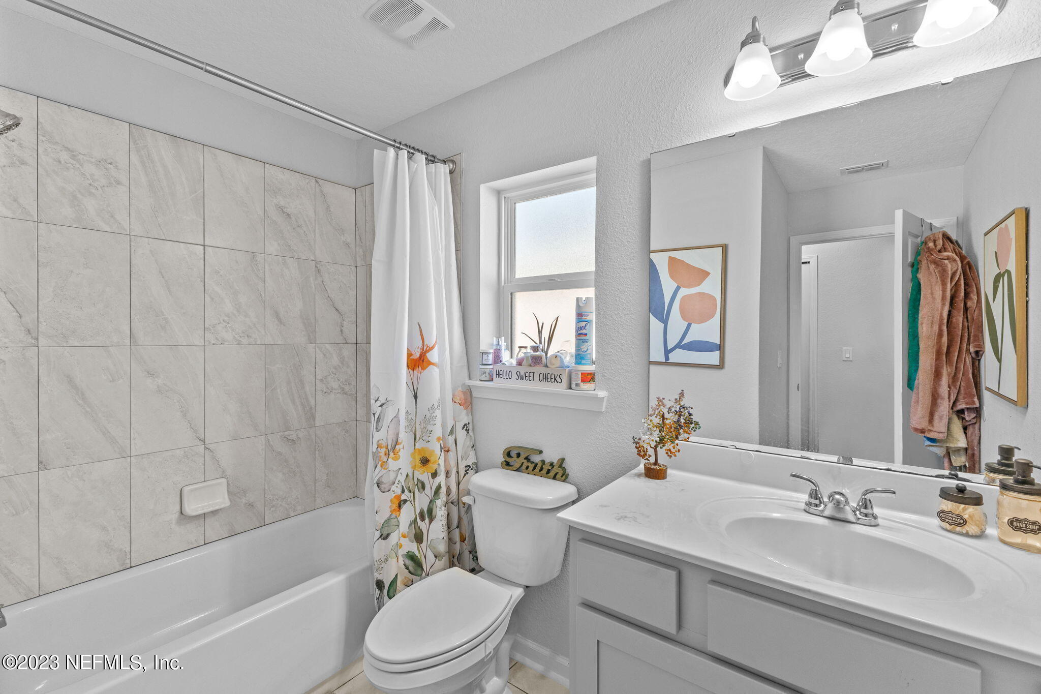 1592 Liberty Tree Place Jacksonville, FL 32221 - Photo 17 of 28 a bathroom with a sink a toilet a mirror a bathtub and shower